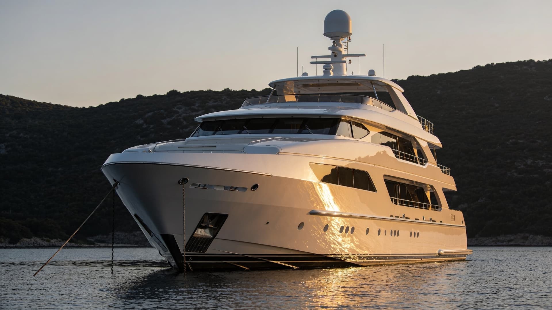 A motor yacht at anchor in the evening